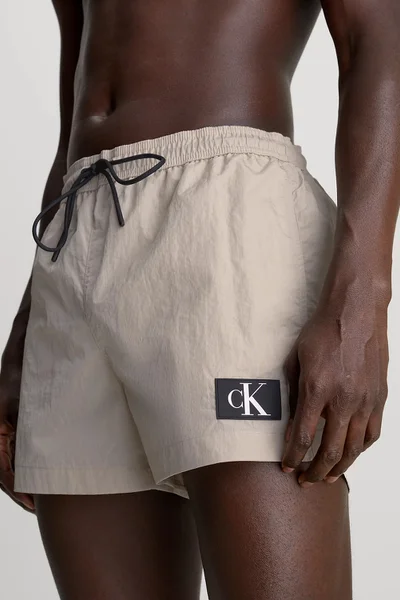 Pánské béžové plavky Calvin Klein s monogramem